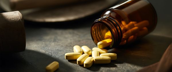 Spilled capsules beside an open bottle